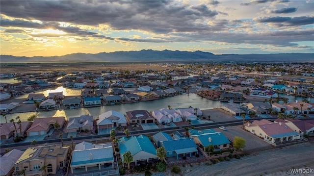 aerial view at dusk with a residential view and a water and mountain view