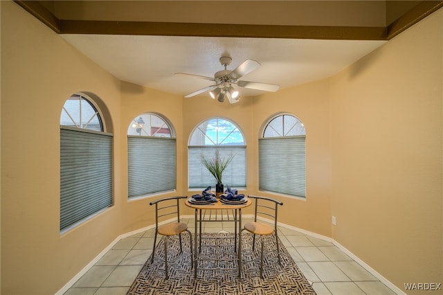 dining room with light tile patterned floors, a ceiling fan, and baseboards