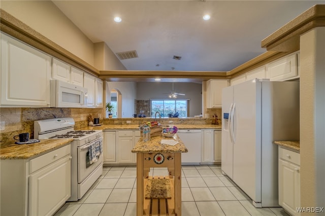 kitchen featuring light tile patterned floors, visible vents, white appliances, and white cabinetry