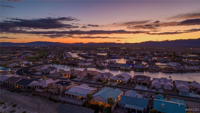 aerial view at dusk with a residential view and a water and mountain view