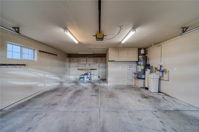 garage featuring gas water heater and a garage door opener