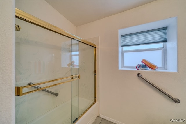 bathroom featuring shower / bath combination with glass door