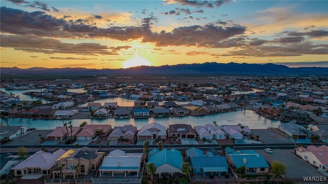 drone / aerial view with a residential view and a water and mountain view