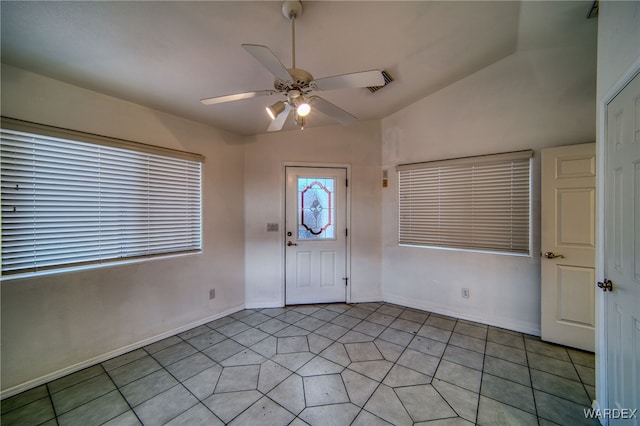 entryway with baseboards, lofted ceiling, and ceiling fan