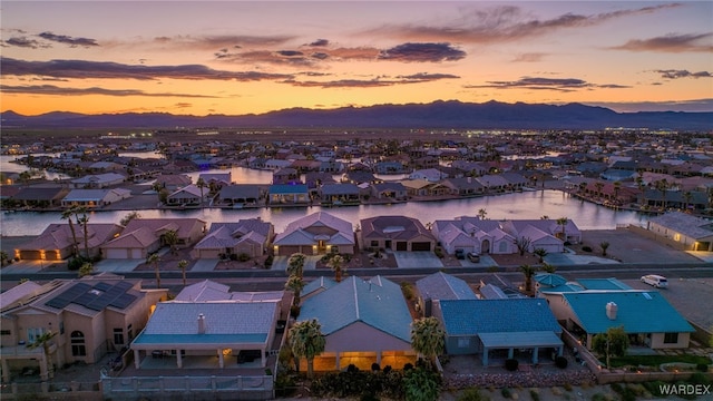 drone / aerial view featuring a residential view and a water and mountain view