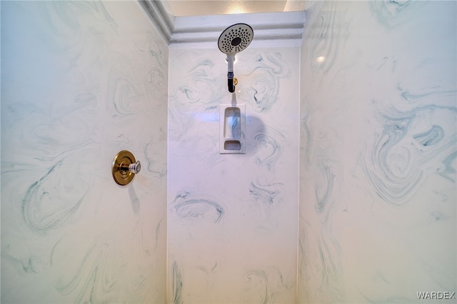 interior details featuring a marble finish shower