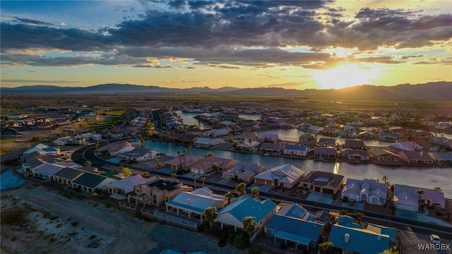 aerial view at dusk with a residential view and a water and mountain view