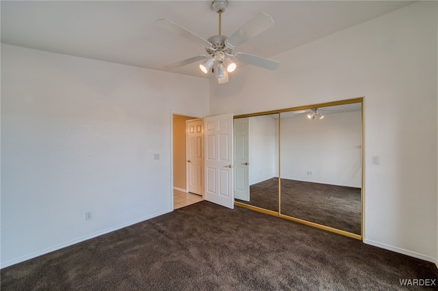 unfurnished bedroom with carpet flooring, a ceiling fan, baseboards, and a closet