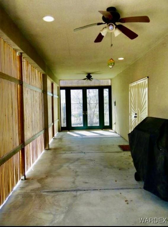 miscellaneous room with french doors and concrete floors