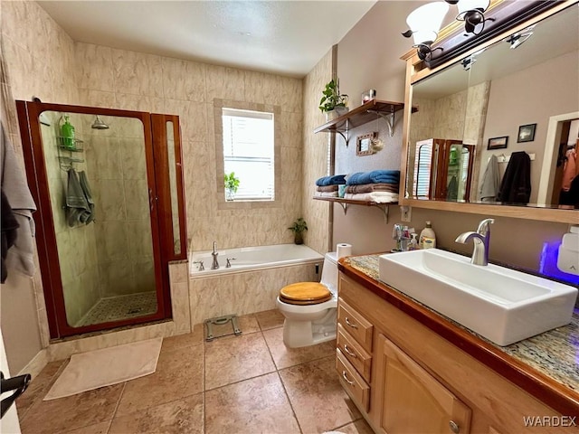 full bath featuring toilet, a bath, and a shower stall