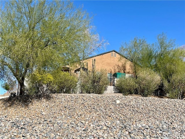 rear view of house with stucco siding