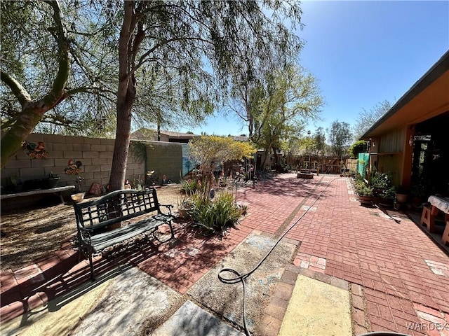 view of patio / terrace featuring a fire pit and a fenced backyard