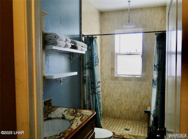 bathroom with a shower stall, vanity, and toilet