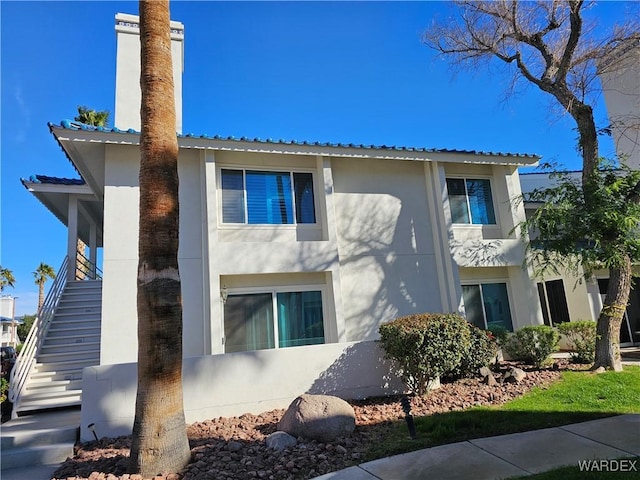 1800 Clubhouse Dr Unit 89, Bullhead City, AZ 86442 - exterior space featuring stairway, metal roof, and stucco siding