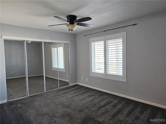 1800 Clubhouse Dr Unit 89, Bullhead City, AZ 86442 - unfurnished bedroom with dark carpet, baseboards, and multiple windows