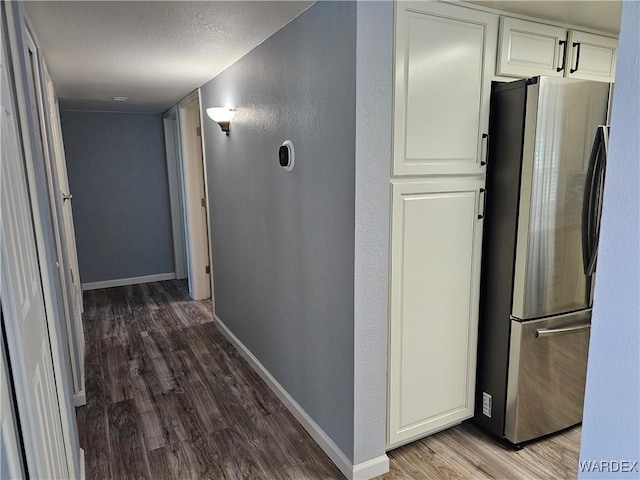 1800 Clubhouse Dr Unit 89, Bullhead City, AZ 86442 - hallway featuring a textured ceiling, wood finished floors, a textured wall, and baseboards