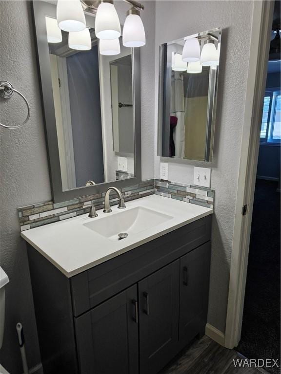 1800 Clubhouse Dr Unit 89, Bullhead City, AZ 86442 - bathroom with backsplash, wood finished floors, vanity, and a textured wall