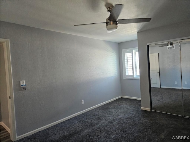 1800 Clubhouse Dr Unit 89, Bullhead City, AZ 86442 - unfurnished bedroom with dark colored carpet, a closet, baseboards, a ceiling fan, and visible vents