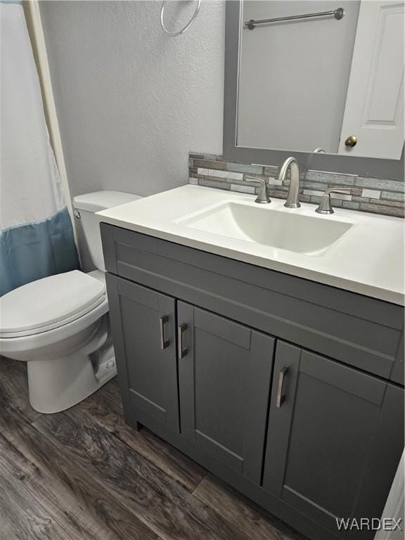1800 Clubhouse Dr Unit 89, Bullhead City, AZ 86442 - full bathroom featuring toilet, wood finished floors, vanity, and a textured wall