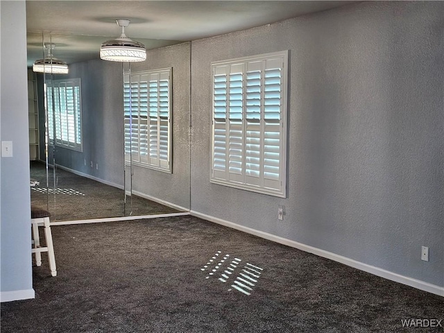 1800 Clubhouse Dr Unit 89, Bullhead City, AZ 86442 - unfurnished dining area with carpet flooring, baseboards, and a textured wall