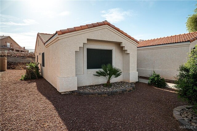 6052 S Bella Vista Dr, Fort Mohave, AZ 86426 - view of side of property featuring stucco siding and a tiled roof