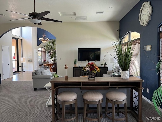 6052 S Bella Vista Dr, Fort Mohave, AZ 86426 - living area with arched walkways, a ceiling fan, visible vents, and carpet