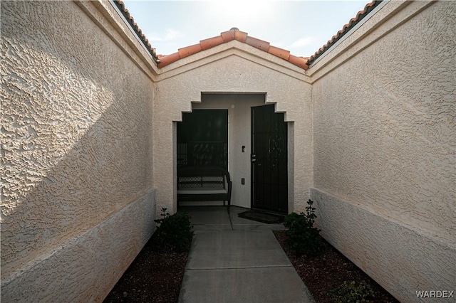 6052 S Bella Vista Dr, Fort Mohave, AZ 86426 - property entrance with a tile roof and stucco siding