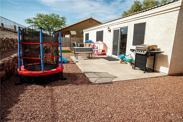 6052 S Bella Vista Dr, Fort Mohave, AZ 86426 - exterior space featuring a trampoline, a patio area, and fence