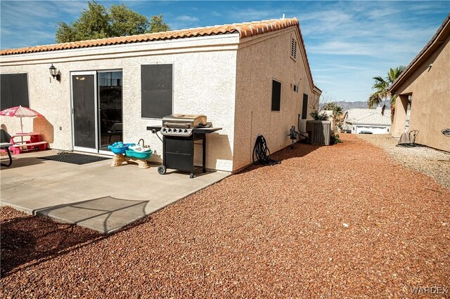 6052 S Bella Vista Dr, Fort Mohave, AZ 86426 - rear view of house featuring central air condition unit, a patio area, and stucco siding