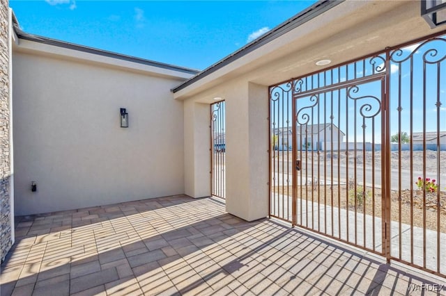 2353 E Calle Toledo, Fort Mohave, AZ 86426 - view of exterior entry with stucco siding, a water view, and a gate