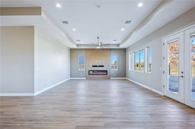 unfurnished living room with light wood-style floors, a fireplace, visible vents, and recessed lighting