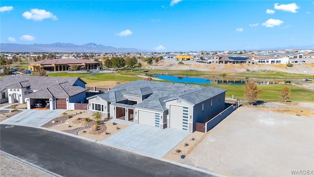 drone / aerial view with a residential view and a water and mountain view