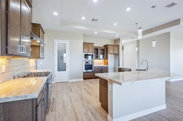 2353 E Calle Toledo, Fort Mohave, AZ 86426 - kitchen featuring appliances with stainless steel finishes, light wood finished floors, tasteful backsplash, and recessed lighting