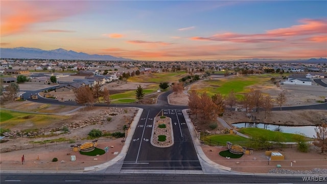 drone / aerial view featuring a residential view and a water and mountain view