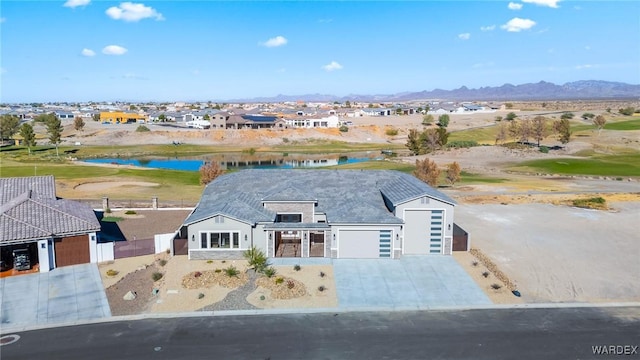 drone / aerial view with a residential view and a water and mountain view