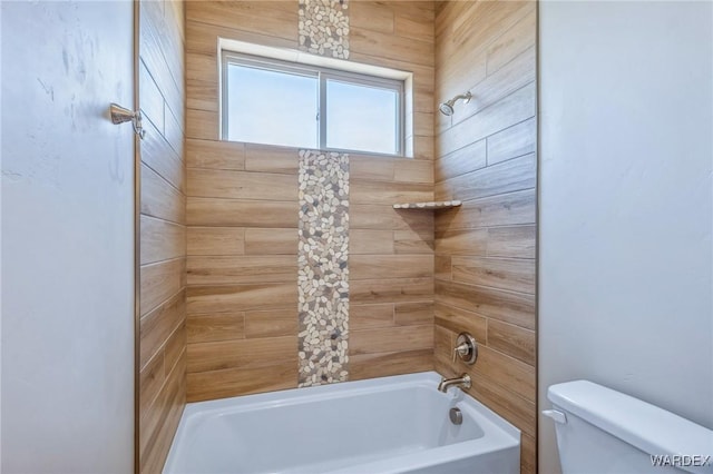 bathroom with shower / bathing tub combination and toilet