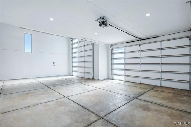 garage with a garage door opener and recessed lighting