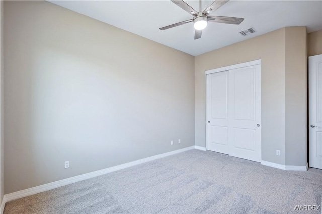 unfurnished bedroom with ceiling fan, carpet flooring, visible vents, baseboards, and a closet