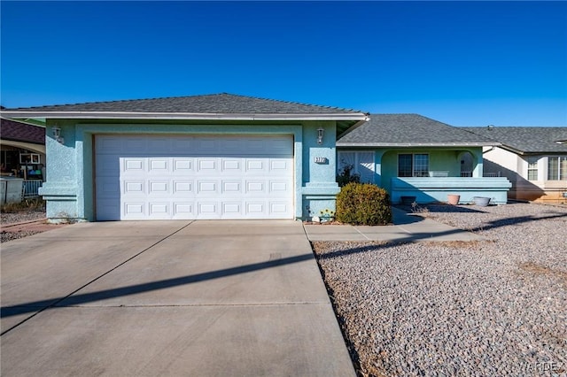 ranch-style home with a garage, concrete driveway, and stucco siding