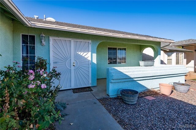 doorway to property with stucco siding