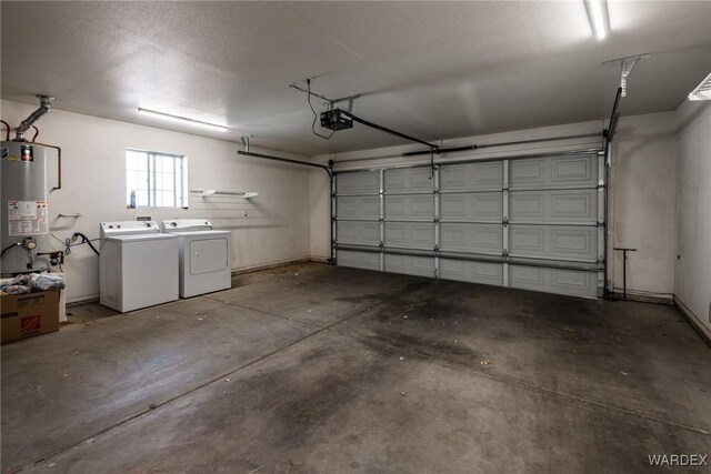 garage featuring water heater, separate washer and dryer, and a garage door opener