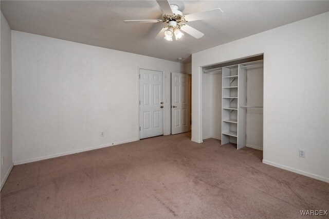 unfurnished bedroom with ceiling fan, baseboards, and light colored carpet