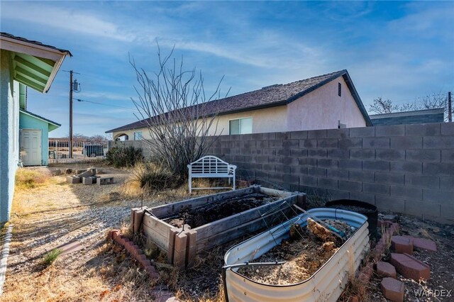 exterior space featuring fence and a garden