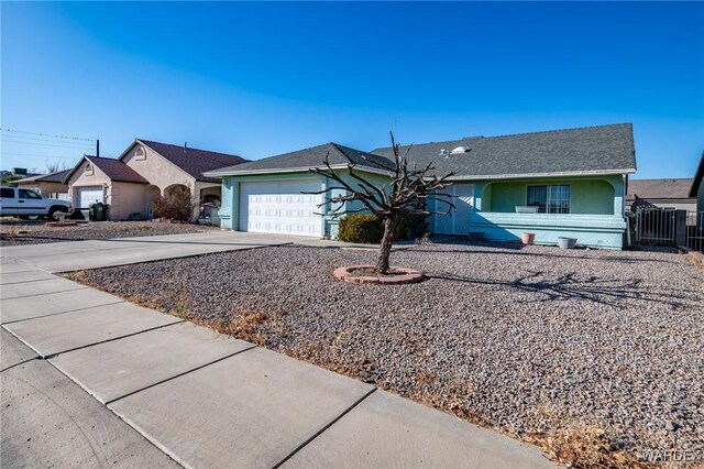 single story home featuring a garage, concrete driveway, and stucco siding