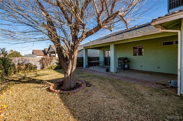 view of yard with fence and a patio