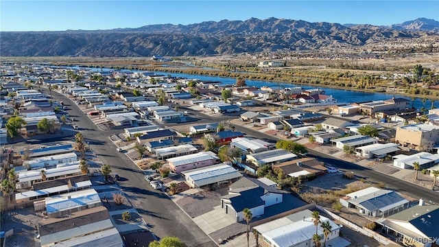 drone / aerial view featuring a residential view and a water and mountain view