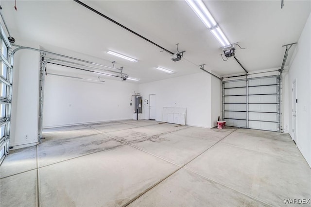 garage with a garage door opener and electric water heater