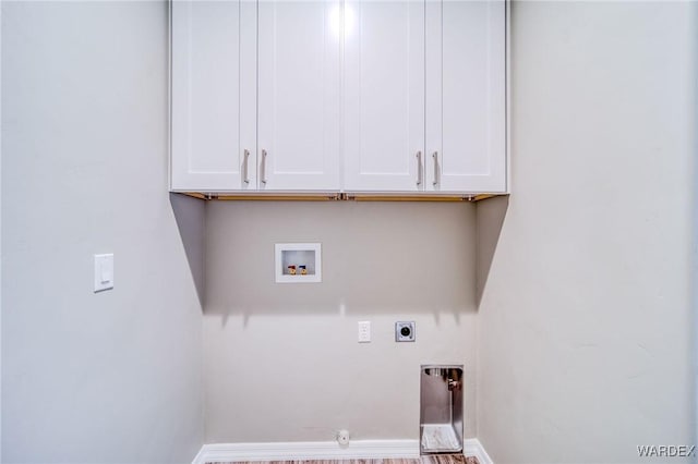 washroom featuring hookup for a washing machine, cabinet space, baseboards, and hookup for an electric dryer