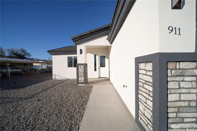 view of property exterior with fence and stucco siding