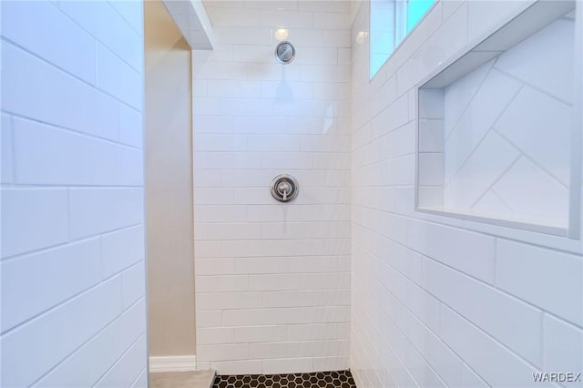 bathroom with tiled shower